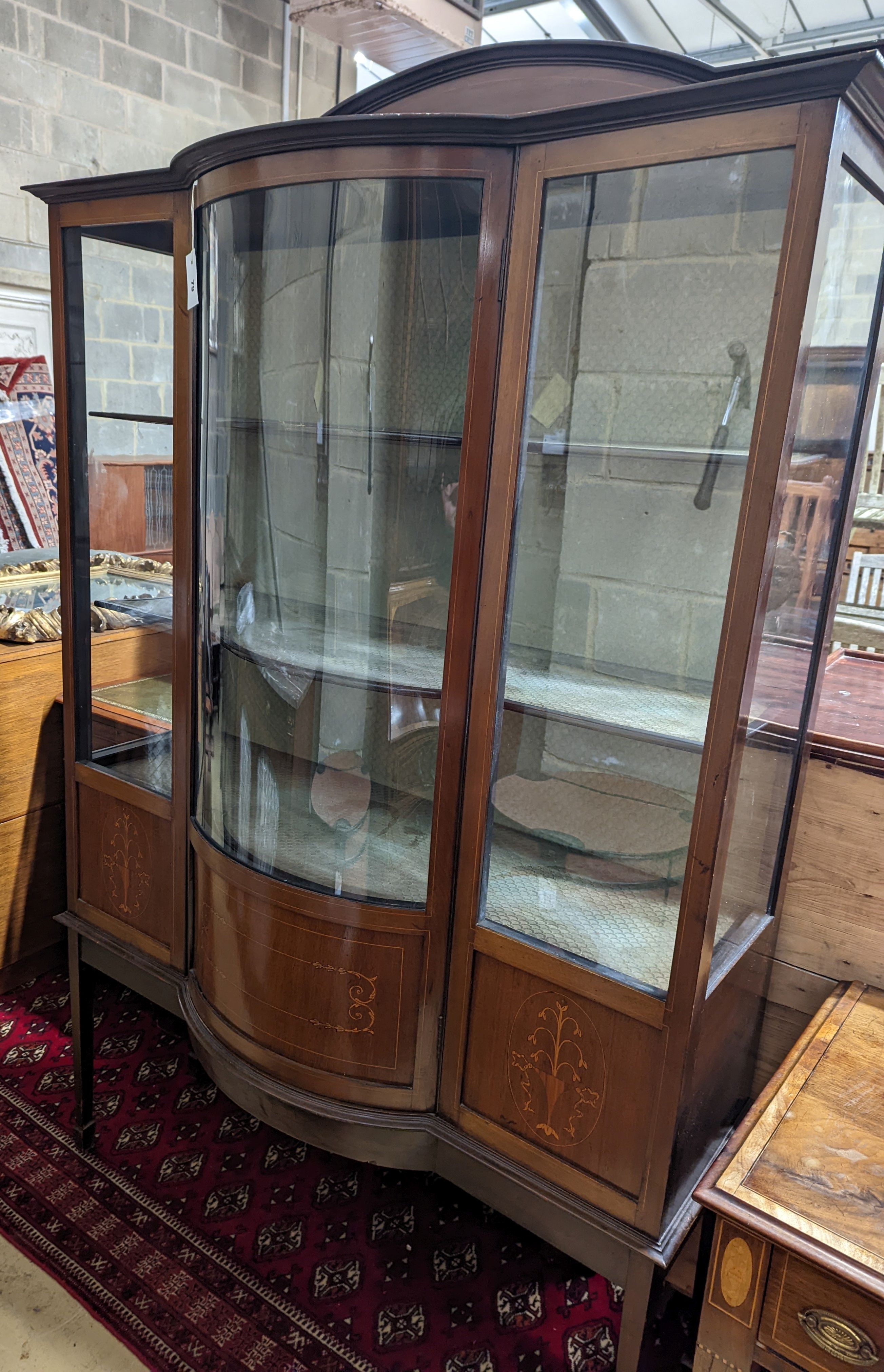 An Edwardian inlaid mahogany bow front display cabinet, width 122cm, depth 48cm, height 196cm